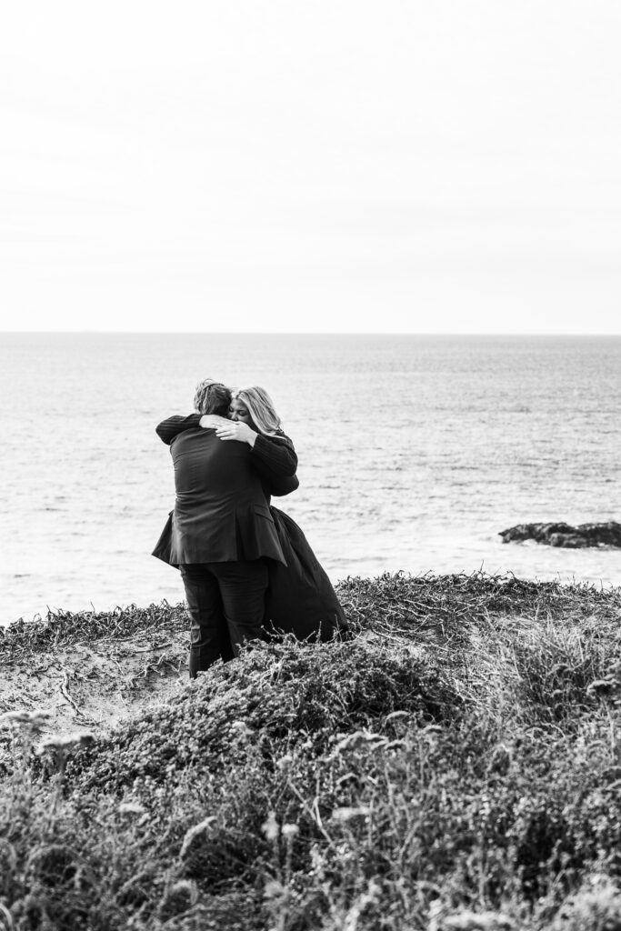 a couple hugging in Big Sur after getting engaged