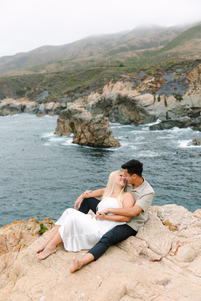 couple nose to nose with Big Sur as their backdrop