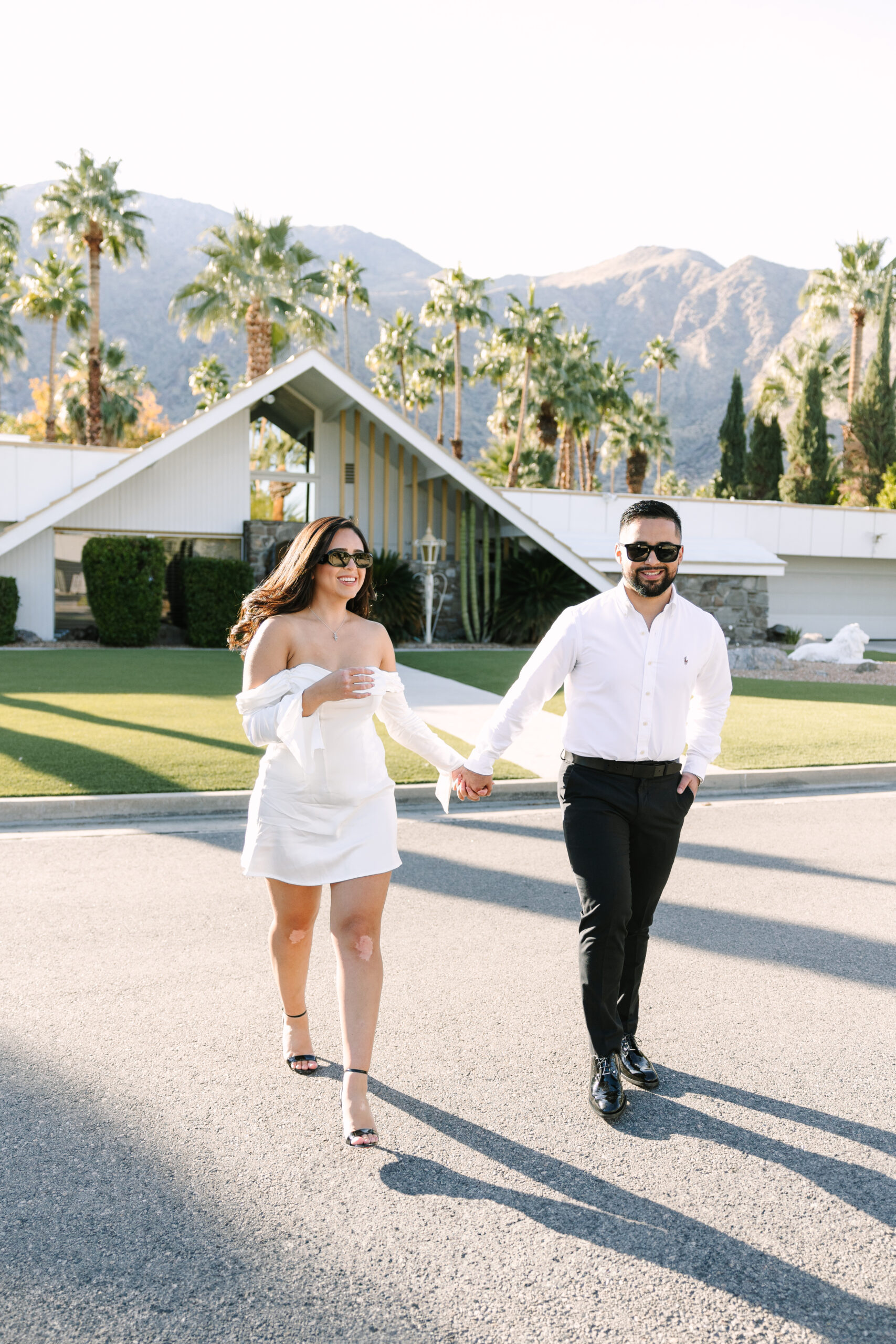 engaged couple strolling through Palm Springs neighborhoods