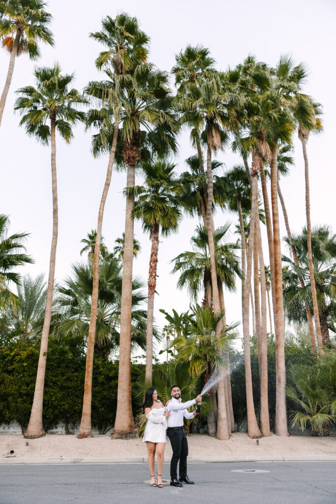 champagne pop engagement photos in Palm Springs