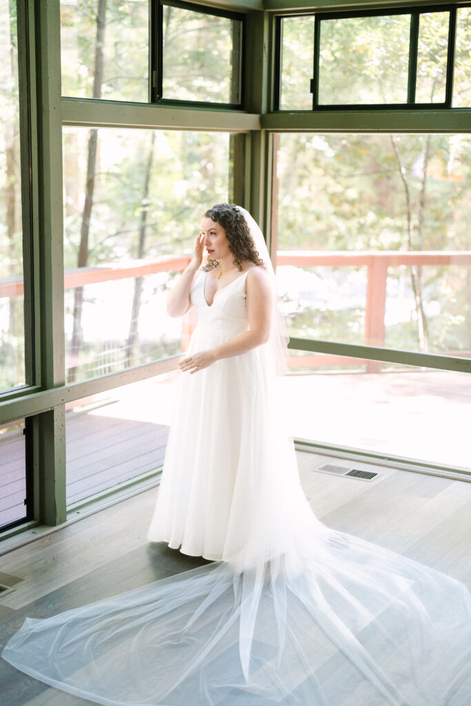 bride getting emotional during her getting ready at YMCA CAMP CAMPBELL