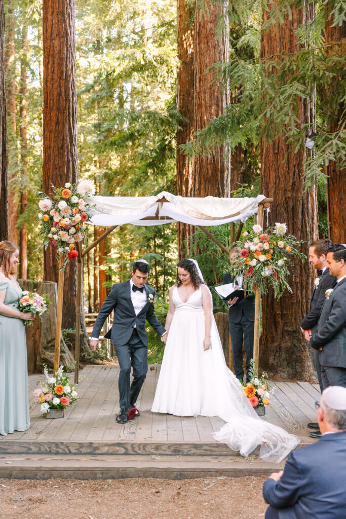 bride and groom break glass for their jewish ceremony